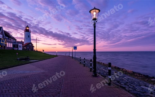 Preview: Urk Flevoland Netherlands sunset at the lighthouse and harbor of Urk Holland