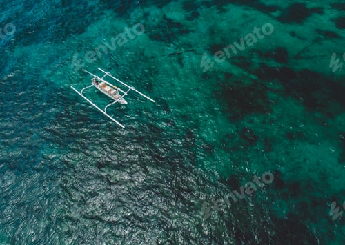 Outrigger Boat Glides on Turquoise Waters