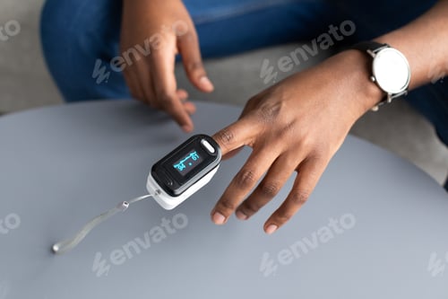 Preview: Closeup Of Pulse Oximeter Clip On Black Male Hand, Cropped