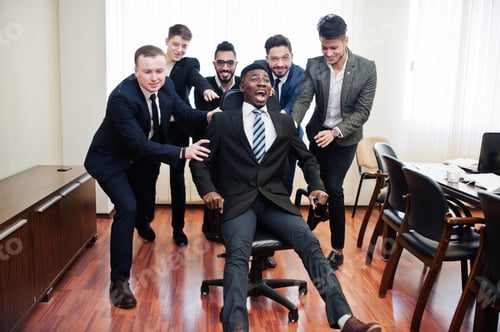 Preview: Multiracial young creative people in modern office