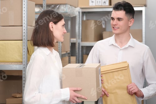 Preview: Post office workers with parcels near rack indoors
