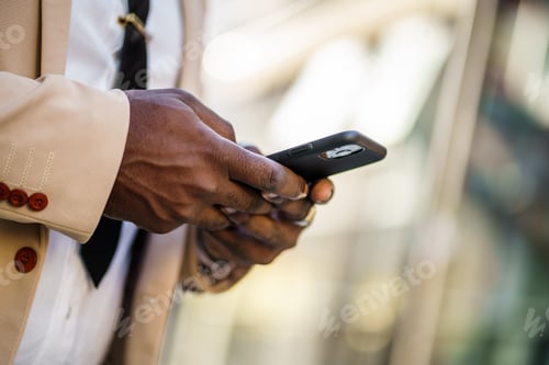 Preview: Businessman typing on smartphone