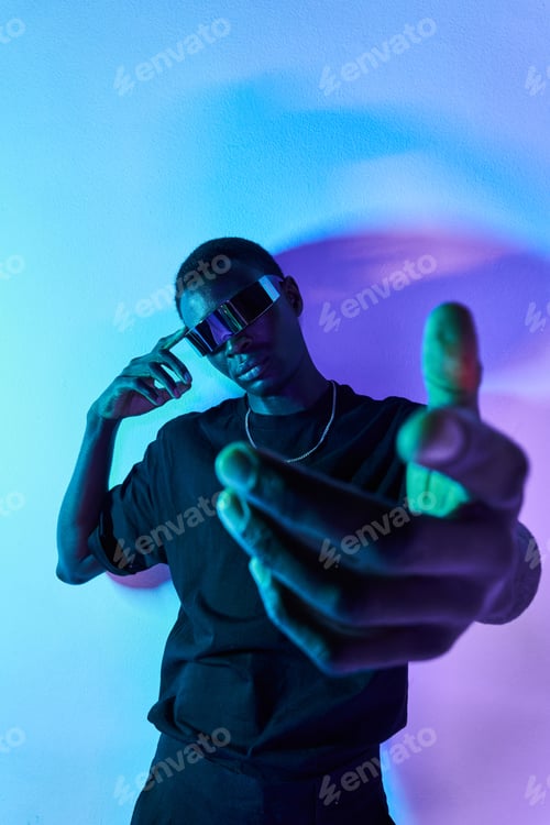 Preview: Confident black man in futuristic headset reaching out hand to camera