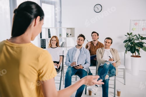 Preview: selective focus of business people listening to female mentor during business training