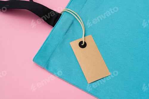 Preview: Textile shopping bag on pink paper background flat lay
