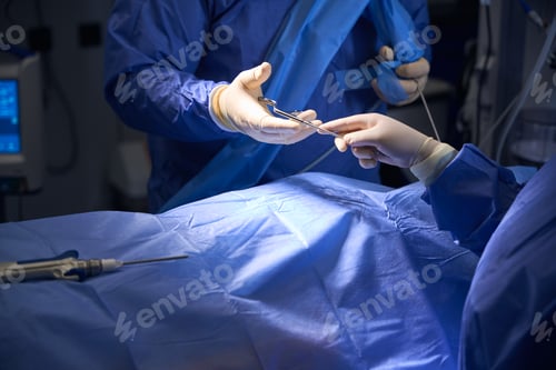 Preview: Close-up of surgeons hands exchanging surgical instruments