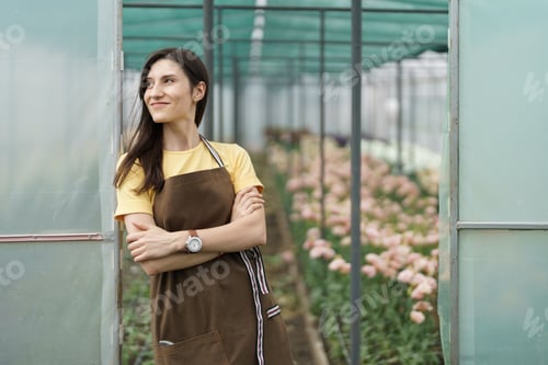 Preview: Smiling florist business woman portrait at the green house.