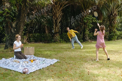 Preview: Family Playing Tennis At Picnic