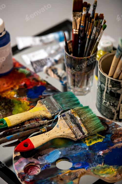 Preview: Variety of paintbrushes and palette with paints for professional painting