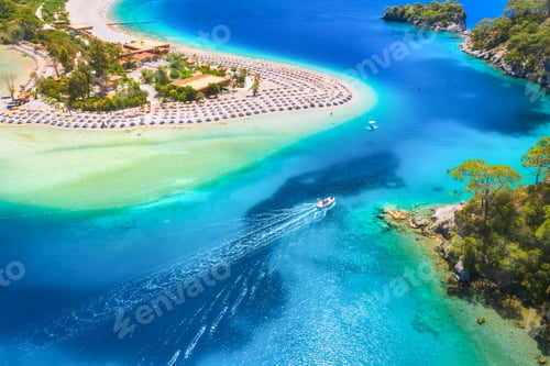 Preview: Aerial view of sandy beach, blue sea and speed boat at sunny day