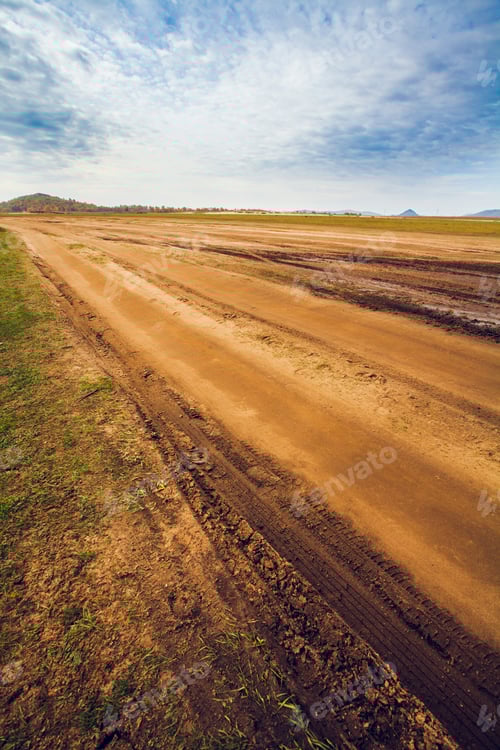 Preview: Dirt Road through Field on a Sunny Day