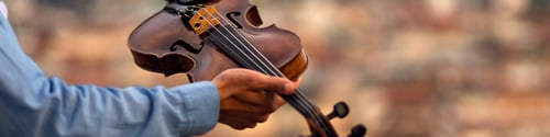 Preview: Linkedin banner with an inspired musician holding a violin in his hand