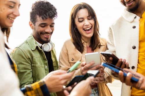 Preview: Happy group of young friends using smartphone in the street