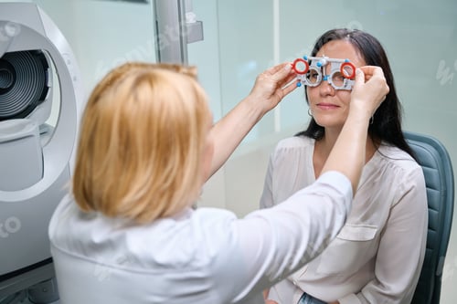 Preview: Optometrist performing binocular subjective refraction on female patient