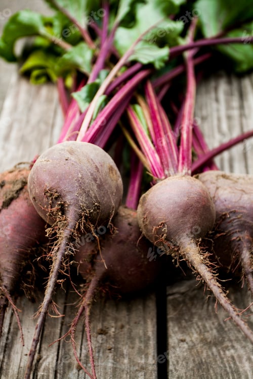 Preview: Organic red beet with green leaves on an old wooden background. Copy space