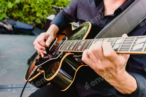Preview: Guitarist playing his guitar outdoors