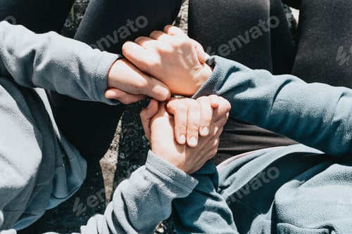 Preview: Close up of two old hands grabbing a young hand on cinematic tones