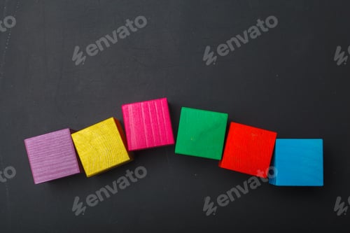 Preview: Wooden toy cubes put on blackboard background