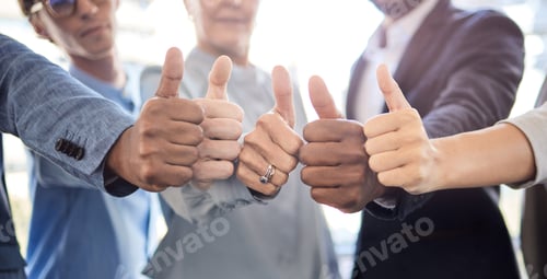 Preview: Closeup shot of a group of unrecognisable businesspeople showing thumbs up together in an office