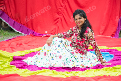 Preview: Young beautiful Indian girl in front of colorful curtains