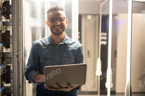 Preview: Cheerful server engineer in datacenter room