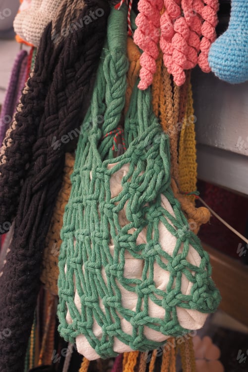 Preview: Handmade green bag hanging among colorful crafts