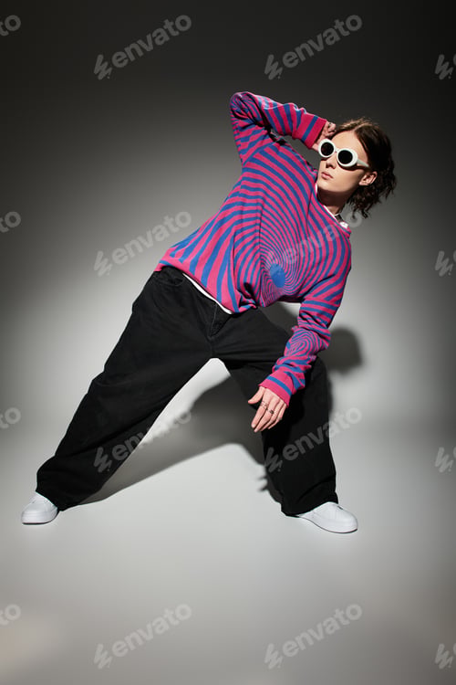Preview: Confident young man showcases unique fashion sense with bold colors and striking sunglasses.