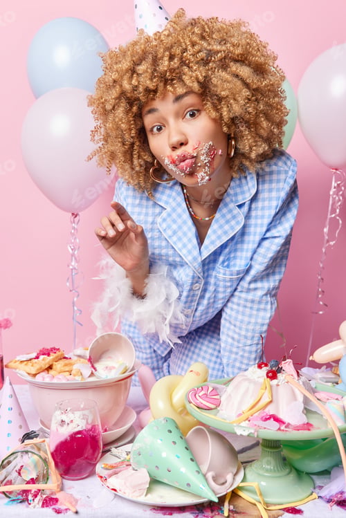 Preview: Lovely curly haired birthday girl rests after party and celebration smeared with cream after eating