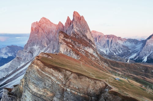 Preview: Landscape of hills and cliffs at the day time. Little buildings on the right side