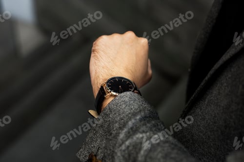 Preview: Man looking at his watch