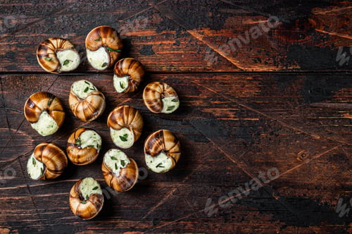 Preview: Snails with garlic butter in a wooden tray. Wooden background. Top view. Copy space