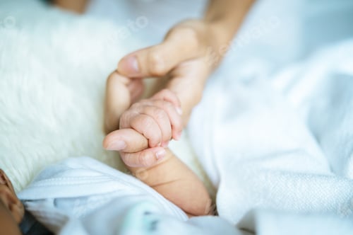 Preview: Newborn baby holding hands mom