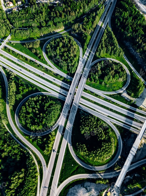 Preview: Aerial top view of Highway and overpass with green forests in Finland.