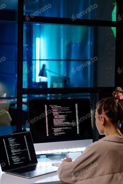 Preview: Young female software developer or programmer working with coded data