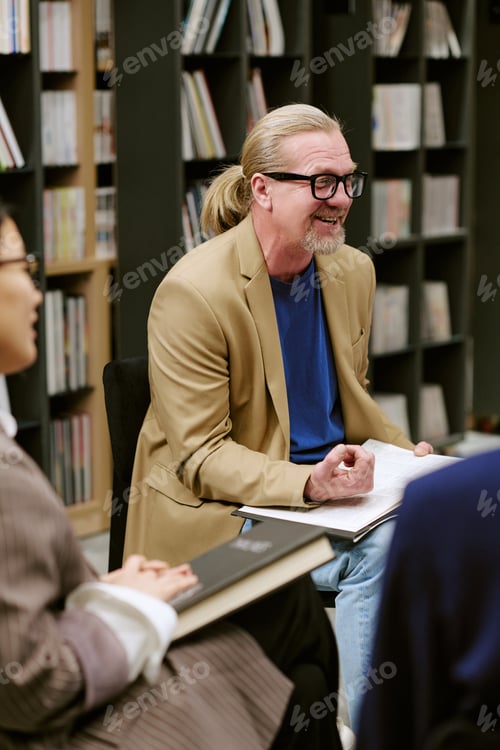 Preview: Middle Aged Caucasian Man Leading Presentation during Book Discussion Meeting