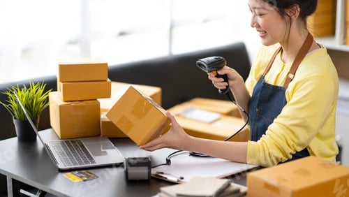Preview: Startup happy Asian woman business owner works with a box at home, prepare parcel delivery SME suppl