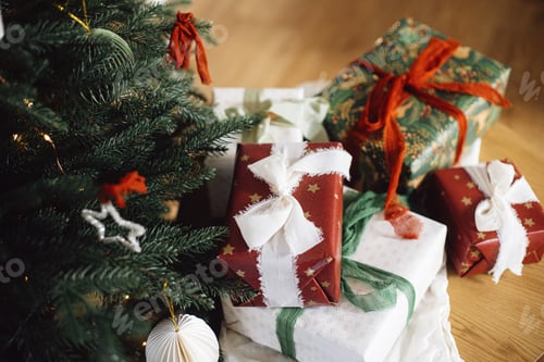 Preview: Stylish Christmas gift boxes on background of decorated xmas tree. Merry Christmas