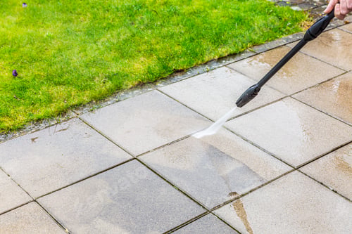 Preview: Detail of cleaning terrace with high-pressure water blaster, cleaning dirty paving stones