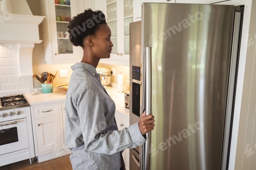 Preview: Woman opening the fridge