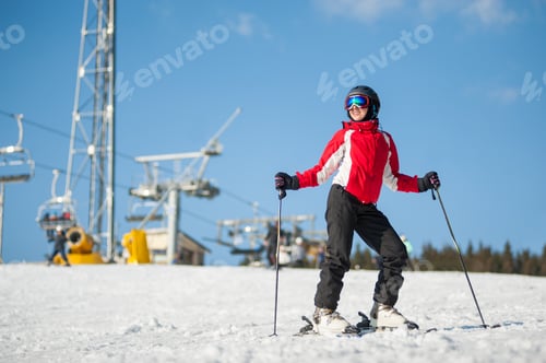 Preview: Woman skier with ski at winer resort in sunny day