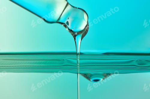 Preview: Pipette dispensing clear serum liquid drops into water