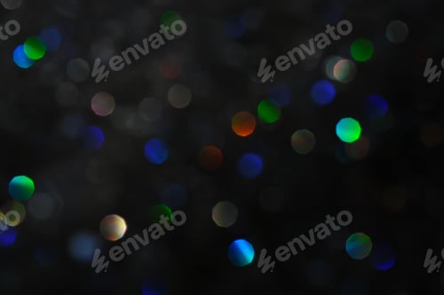 Preview: Abstract black background with bokeh of different colors.