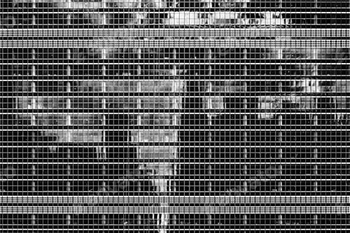 Preview: Greyscale shot of a modern building reflecting the life it witnesses