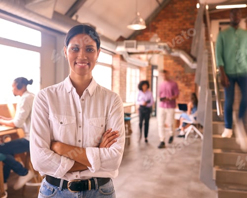 Preview: Portrait Of Smiling Young Businesswoman Working In Modern Open Plan Office