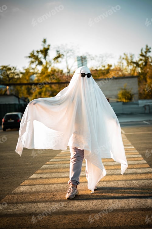 Preview: Celebrating halloween. Ghost Challenge 2021. Spooky trend season. A man dressed as a ghost from a sh