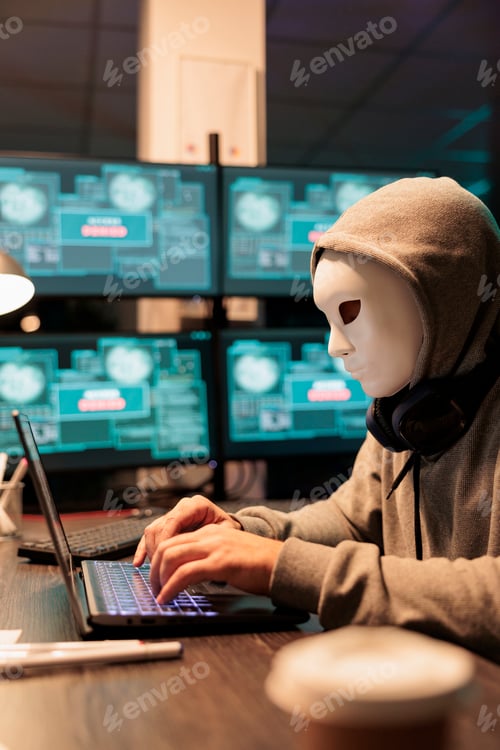 Preview: Scary male scammer wearing mask hacking database