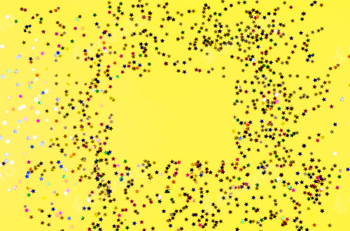 Preview: Shining colorful stars on yellow background.