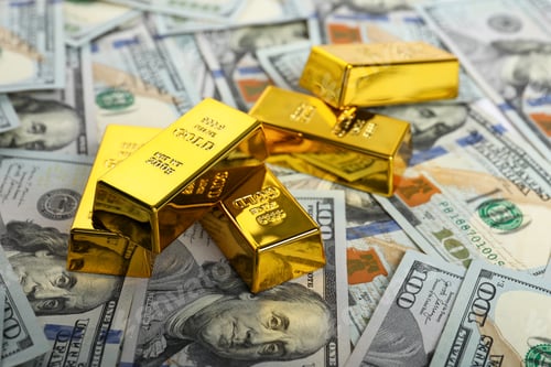Preview: Shiny gold bars on dollar banknotes, closeup