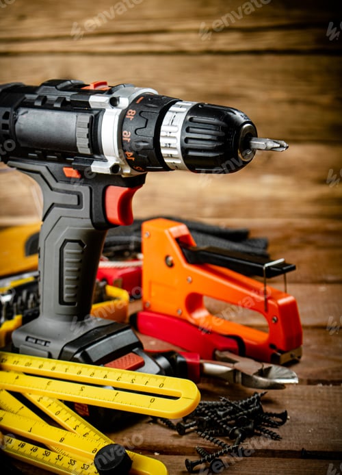 Preview: Power Drill and Construction Tools on Wooden Surface