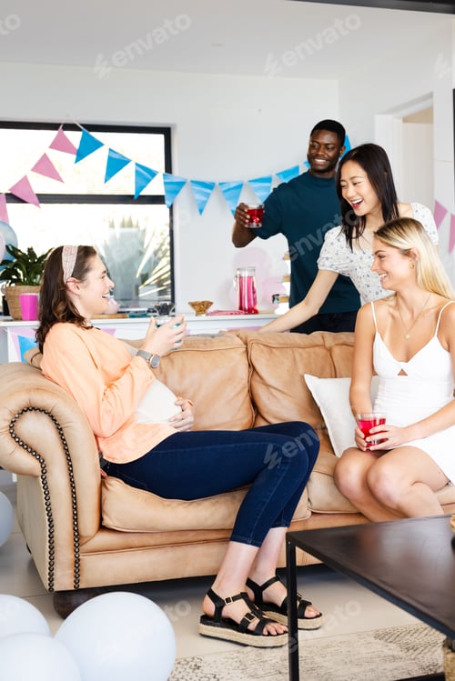 Preview: Friends celebrating at home, enjoying drinks and laughter on cozy sofa